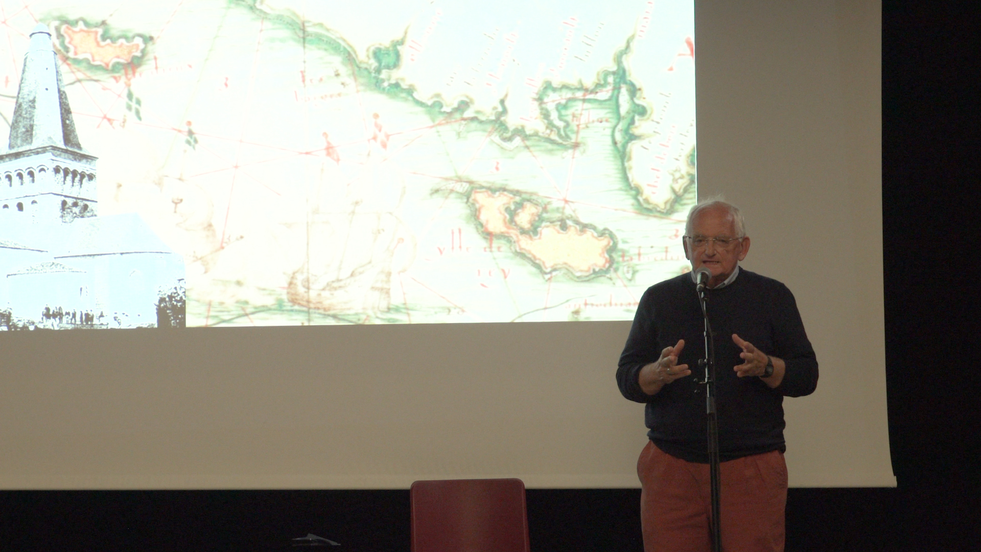 Conférence « Histoire et légendes île d'Yeu » : un intervenant devant une carte ancienne de l'île